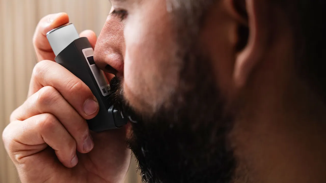 A close-up image of a man using an inhaler, highlighting respiratory health concepts.