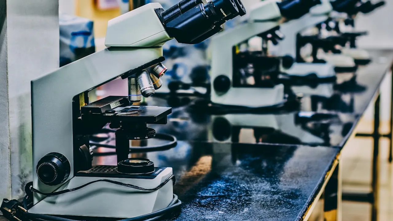 white microscope on top of black table