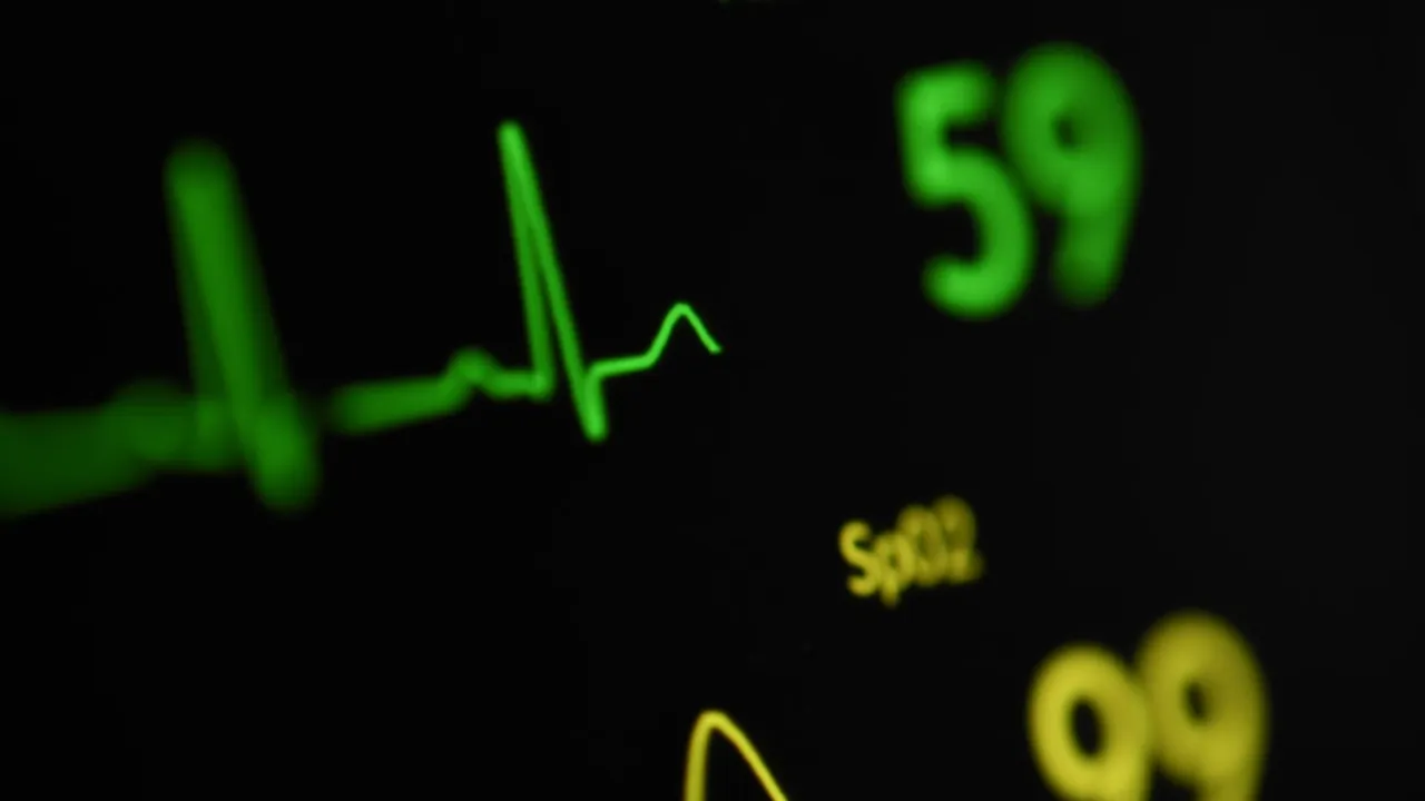 a close up of a clock with a heartbeat on it