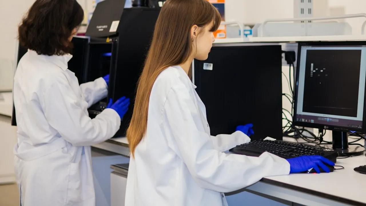 Two scientists working on computers in a laboratory