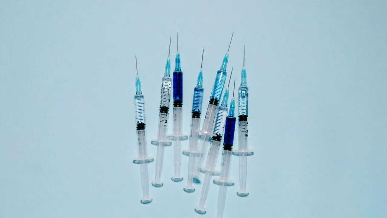 A cluster of medical syringes with blue fluid, ideal for healthcare and vaccination themes.