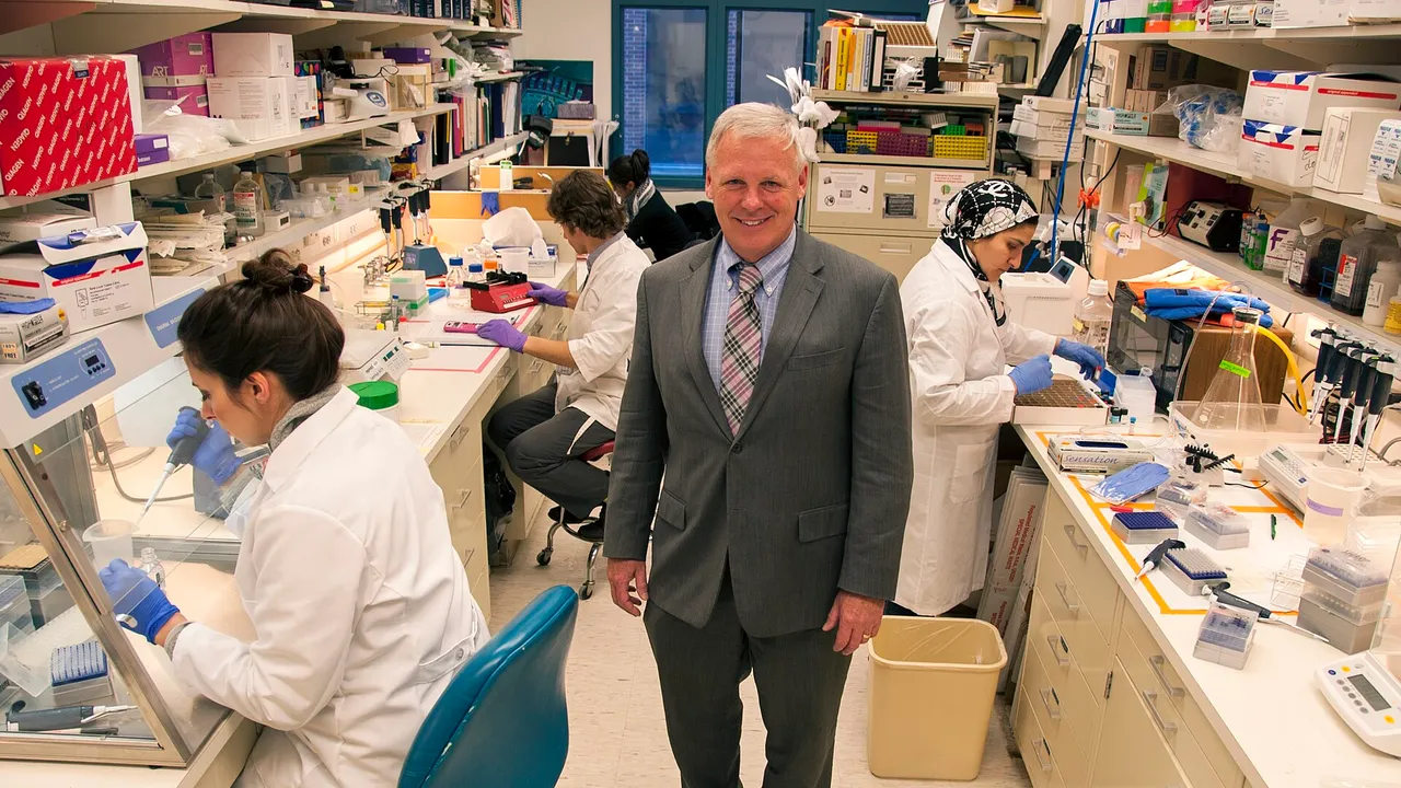 Steven Bauer, Ph.D., chief of the Cellular and Tissue Therapy Branch in FDA’s Office of Cellular Tissue and Gene Therapies (standing), visits his team of scient
