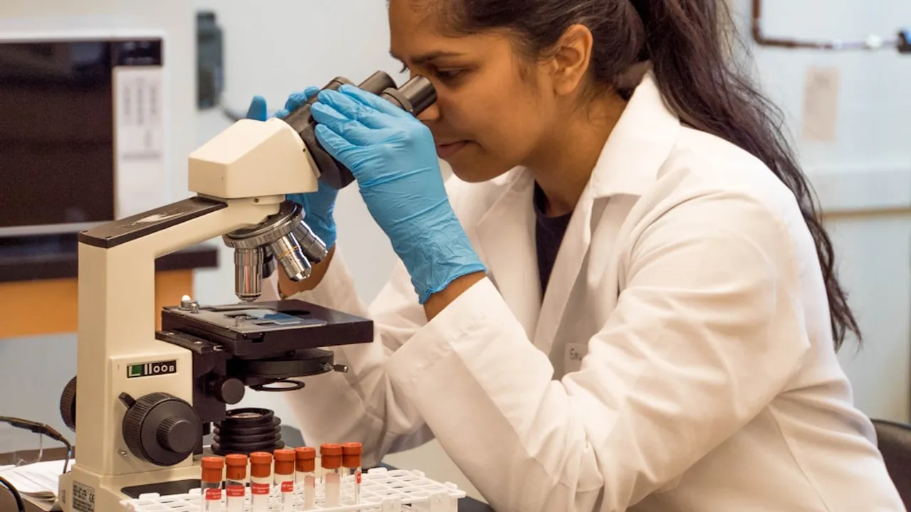 woman looking on microscope inside room