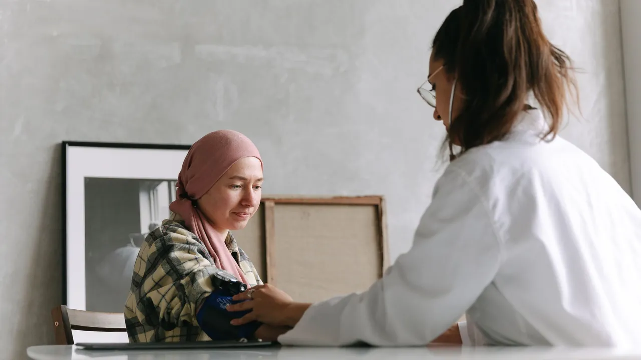 Healthcare professional checks temperature with digital thermometer during patient consultation in a medical office undefined