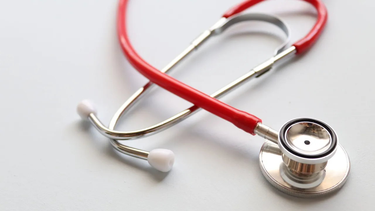 Close-up of a red stethoscope symbolizing medical care and healthcare diagnostics.