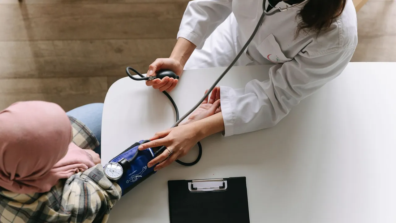Doctor checking patient's vitals in a clinical setting for health consultation.