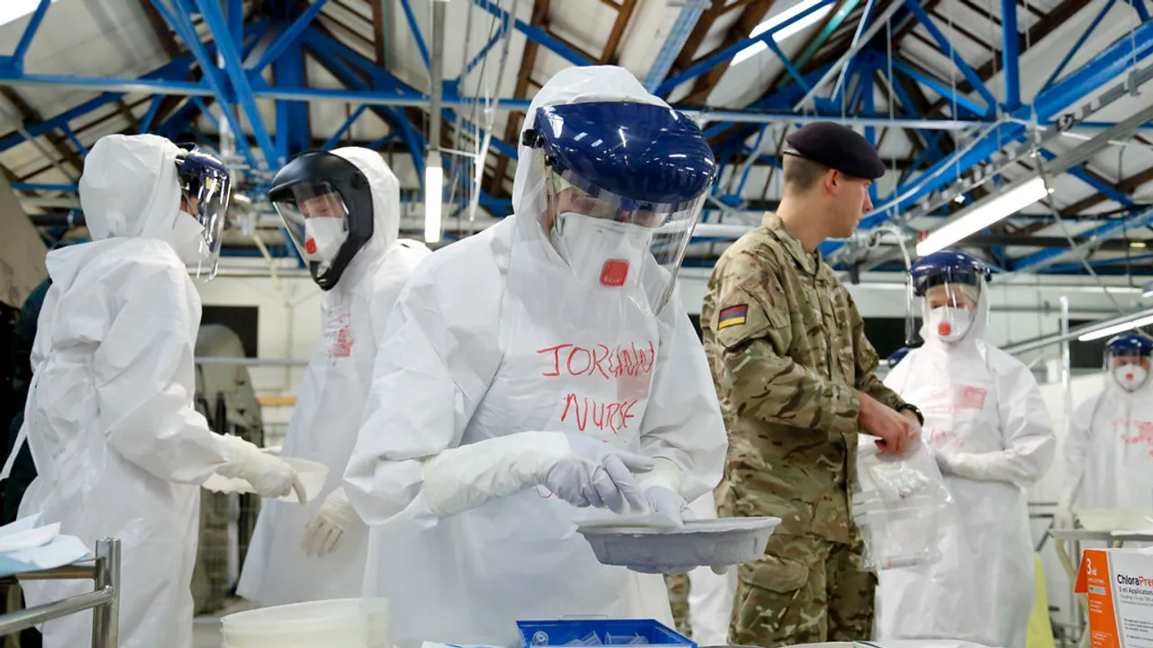 NHS doctors and nurses practise medical care in full protective Ebola gear