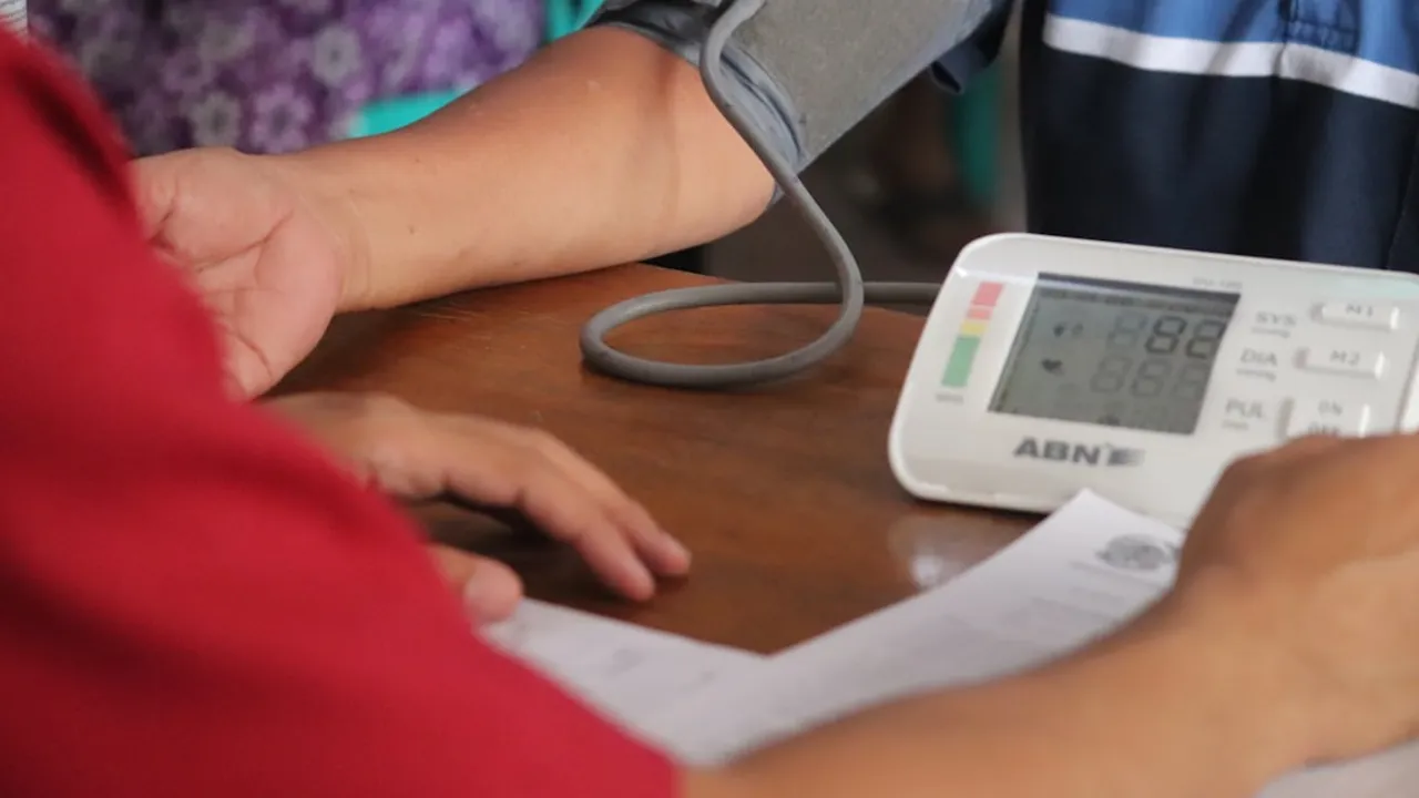 a person with a blood pressure meter on a table