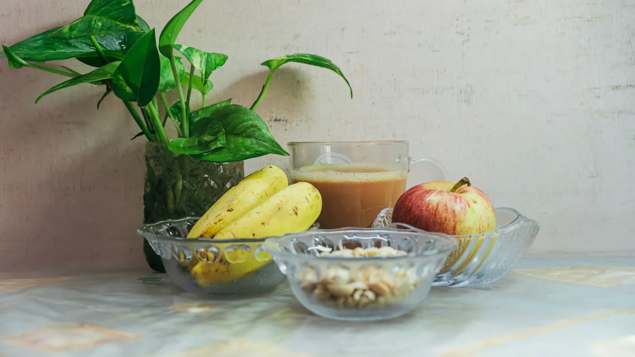 Refreshing breakfast arrangement with fruit, nuts, and tea for a healthy start.